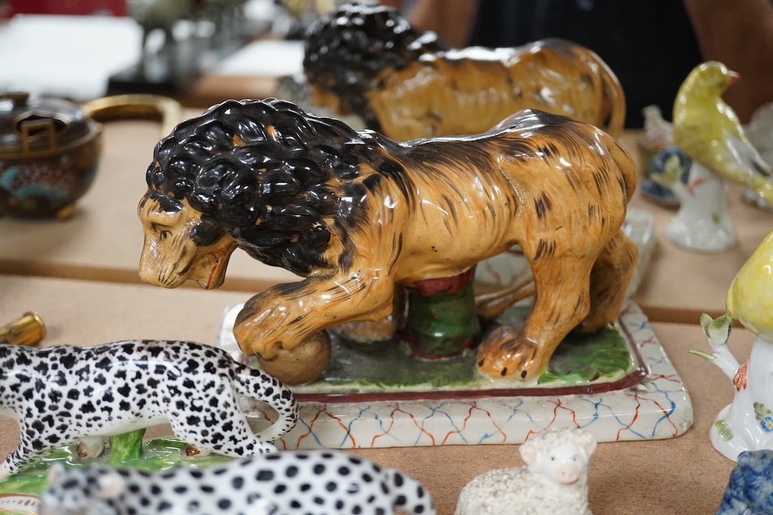 A collection of 19th/20th century Staffordshire and continental porcelain models of animals and birds, including a 20th century Meissen figure of a canary, two Continental porcelain Panthers, two similar recumbent dogs,